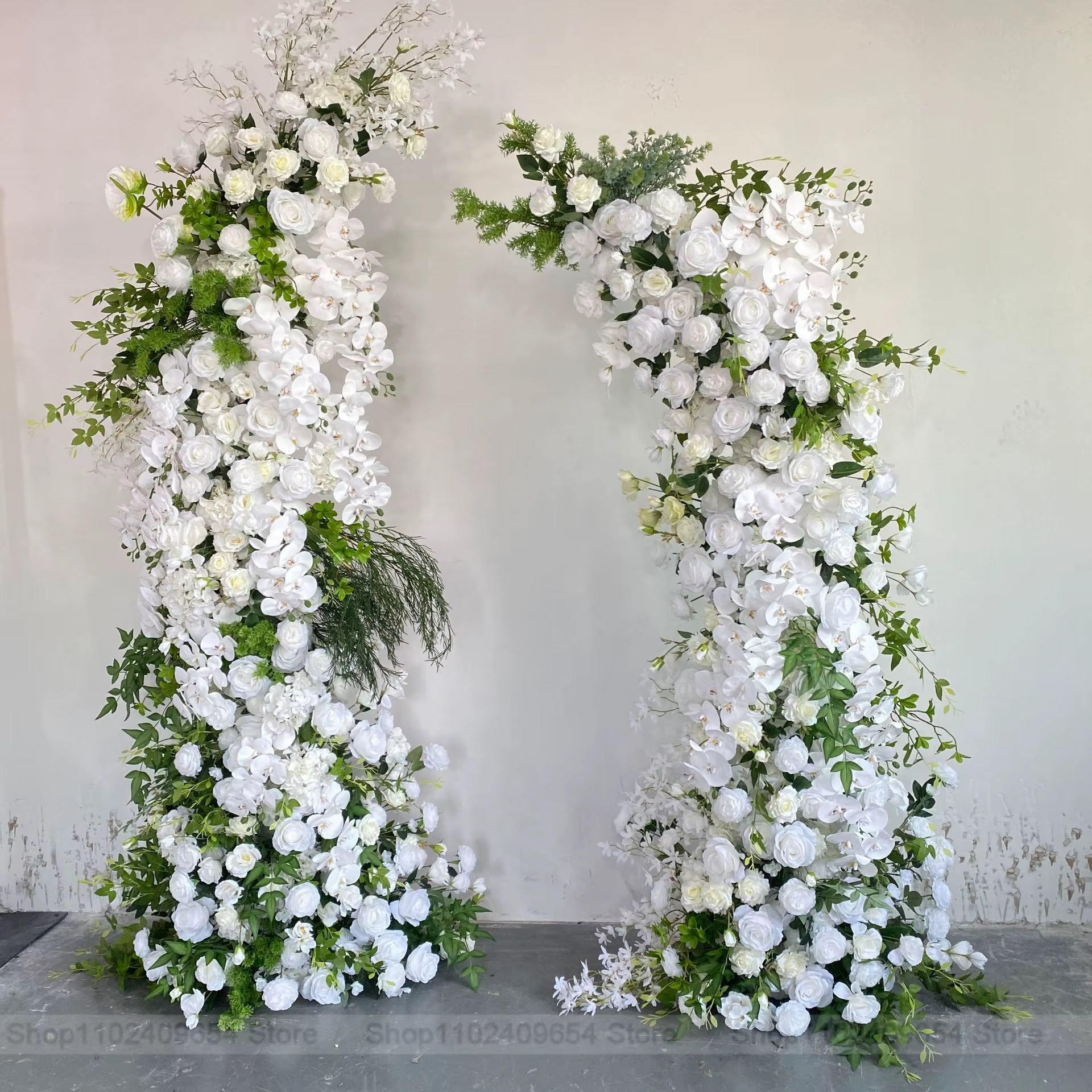 Décoration florale de mariage avec rangée de roses blanches et feuilles vertes