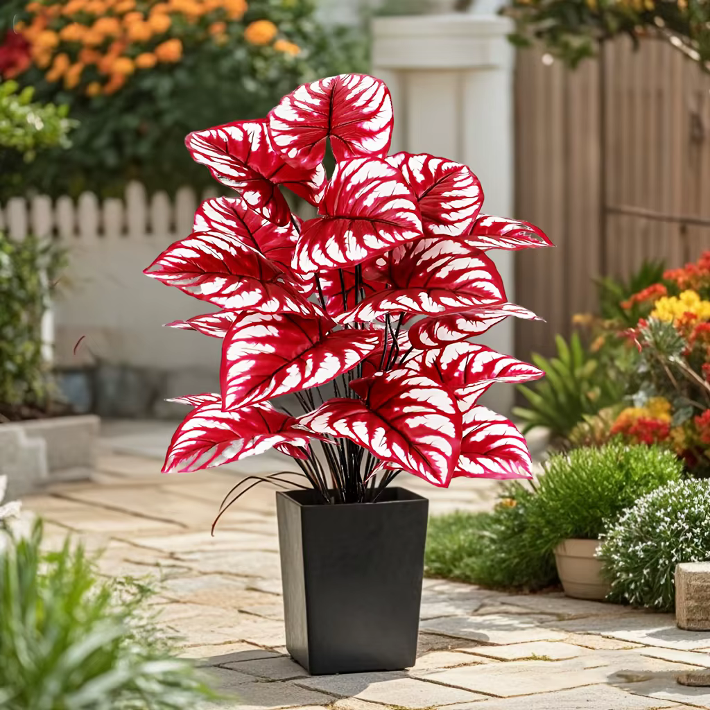 Plante artificielle à feuilles rouges avec rayures blanches